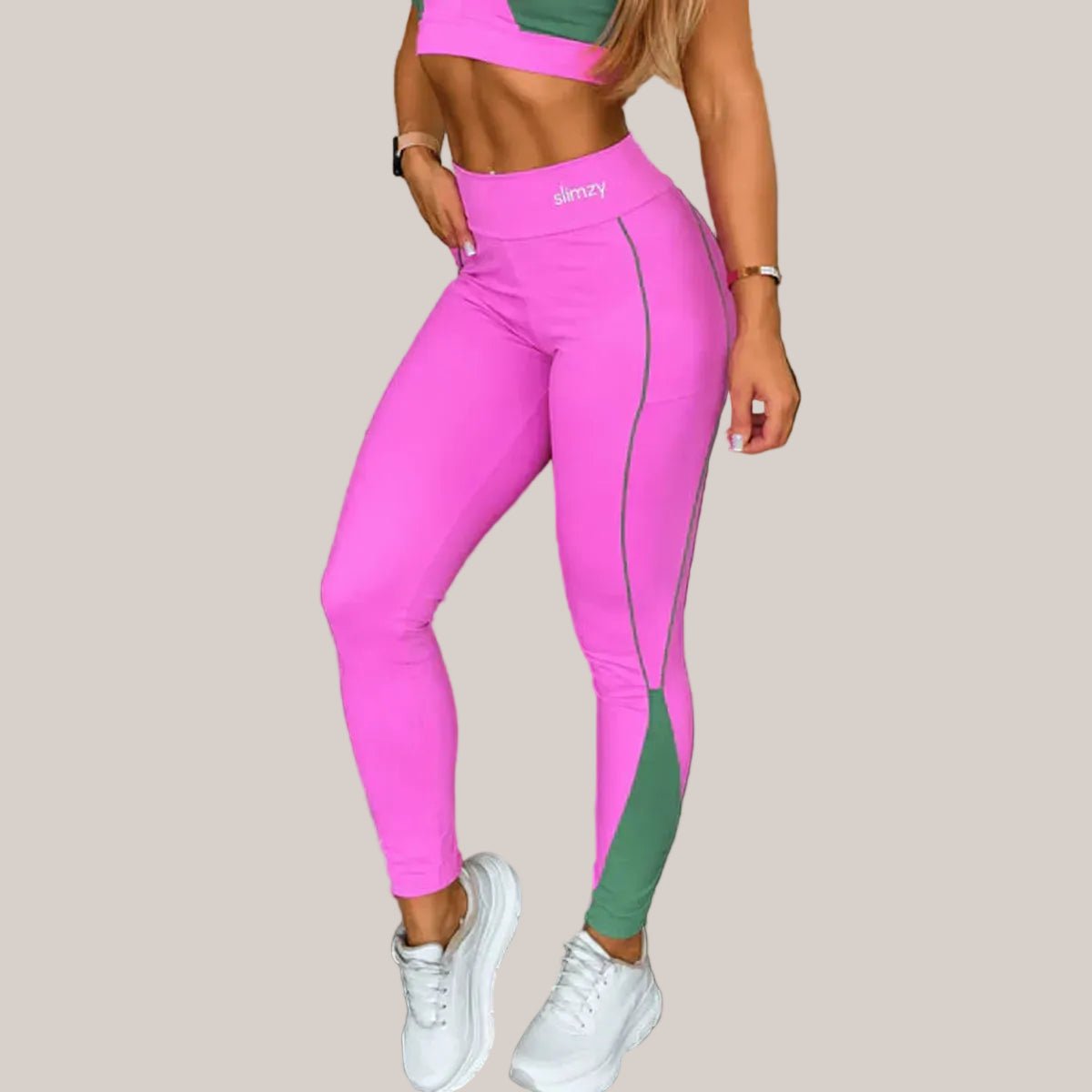 Pink and green Slimzy women's performance leggings with piping detail, showcasing a snug fit and stylish athletic design.
