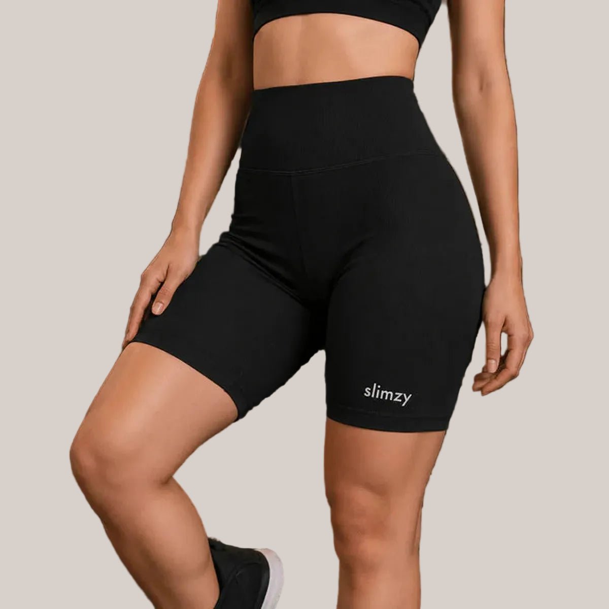 Black ribbed high-waisted fitness shorts for women by Slimzy, featuring a snug fit and comfortable stretch fabric.