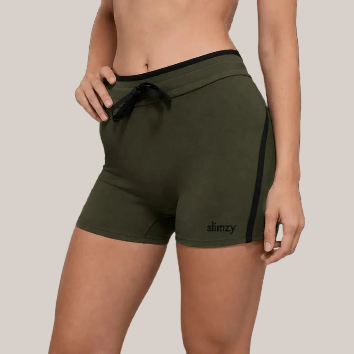 Dark green Slimzy women's drawstring fitness performance shorts laid flat, showcasing lightweight, breathable fabric and comfortable fit.