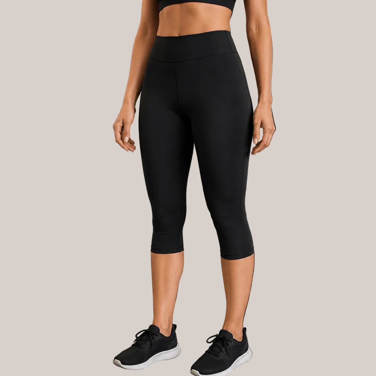 Black Slimzy women's high-waisted performance capri trousers displayed on a hanger with a plain background.