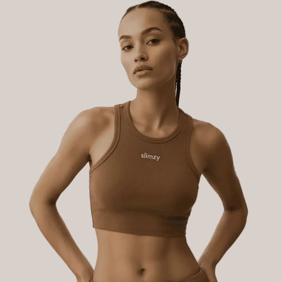 Slimzy women's ribbed brown cropped sports T-shirt displayed on a model, featuring a fitted design and casual athletic style.